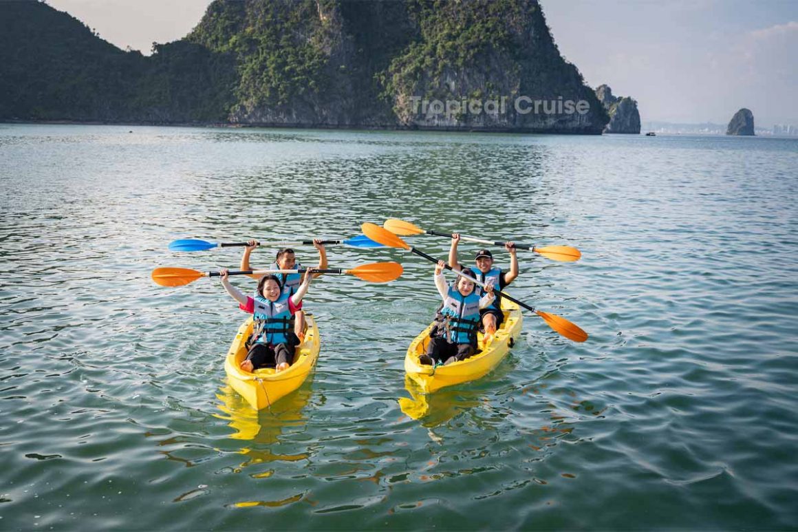 Lan Ha Bay 1 Day – Kayaking Through Limestone Mountains Travelers kayaking between limestone cliffs on Lan Ha Bay 1 day tour