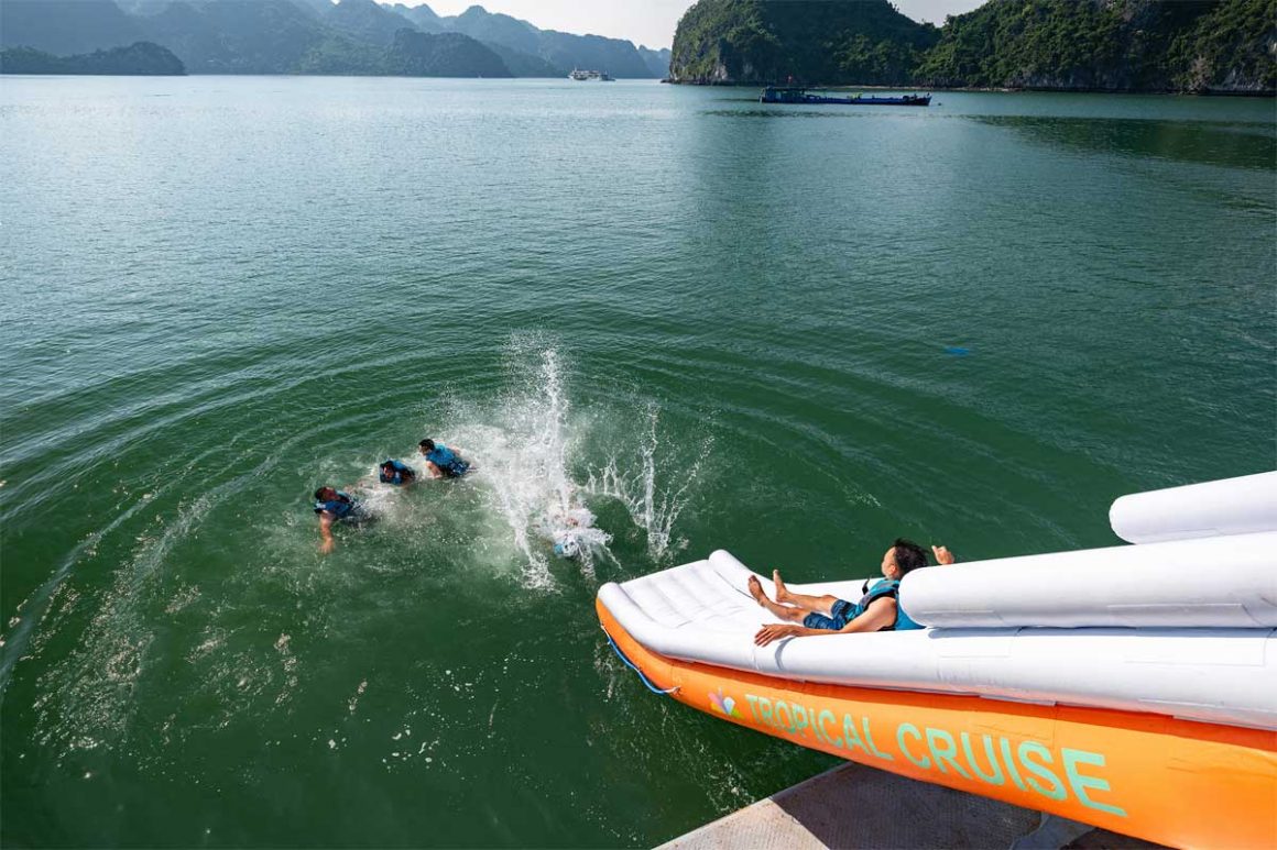 Lan Ha Bay 1 Day – Fun Water Slide from Cruise to the Sea Guests sliding from the cruise into the sea during Lan Ha Bay 1 day tour