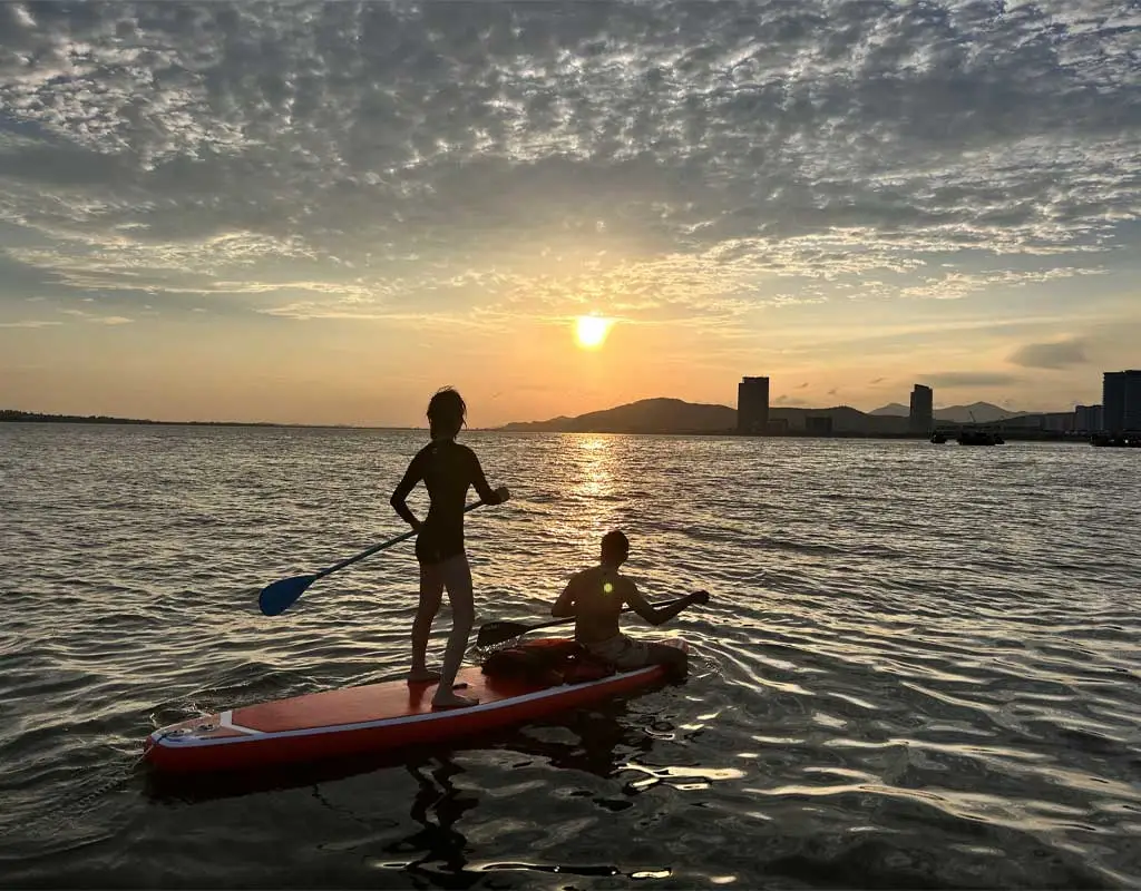 SUP paddleboarding among limestone islands in Halong Bay