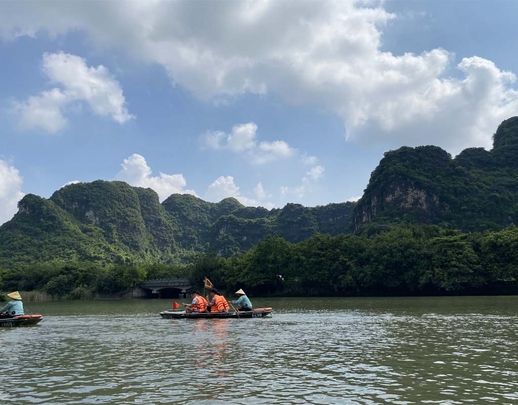 Boat tour through limestone karsts and caves in Trang An, Ninh Binh, Vietnam