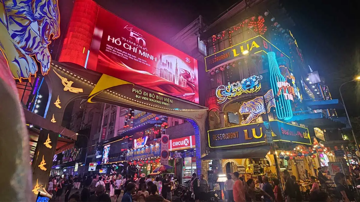 Crowds enjoying the vibrant nightlife at Bui Vien Walking Street in Ho Chi Minh City, Vietnam.