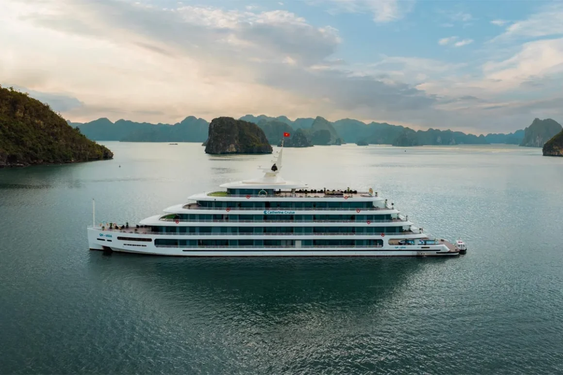 Panoramic exterior view of Catherine Cruise Halong Bay luxury vessel sailing across emerald waters