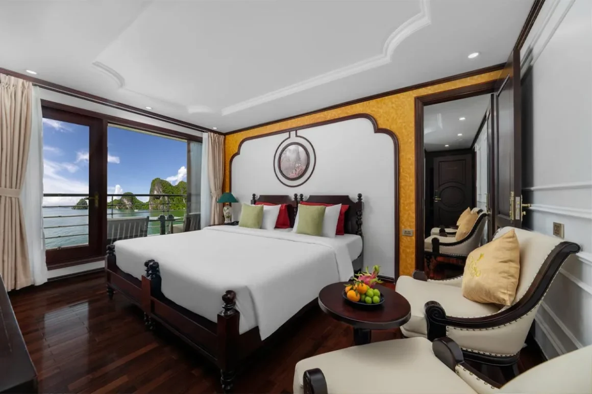 Junior Balcony Suite Cabin - Cycad Cruise Junior Balcony Suite cabin on Cycad Cruise featuring a plush double bed, wooden furnishings, and a private balcony