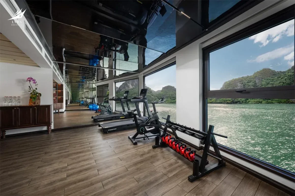 Lyra Grandeur Cruise Modern Ocean-View Gym Modern fitness center onboard Lyra Grandeur Cruise Lan Ha Bay equipped with treadmills and bay-facing windows