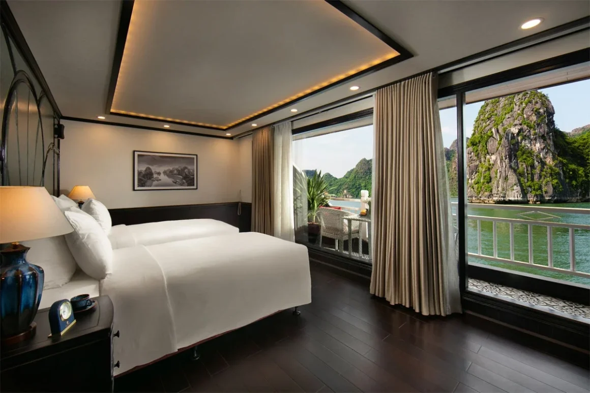 Hermes Cruise Halong Bay Junior Suite with Private Balcony Junior Suite Balcony cabin with plush double bed and private ocean-facing terrace on Hermes Cruise Halong Bay