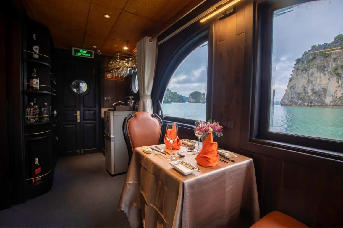 Intimate indoor dining setup on L'Amour Junk with teak wood decor