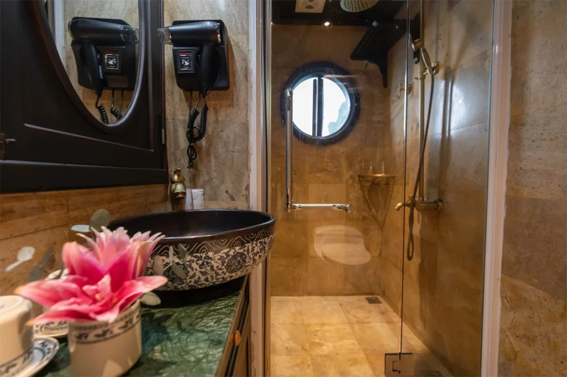 Luxury en-suite wooden bathroom with sea-view window on L'Amour Junk